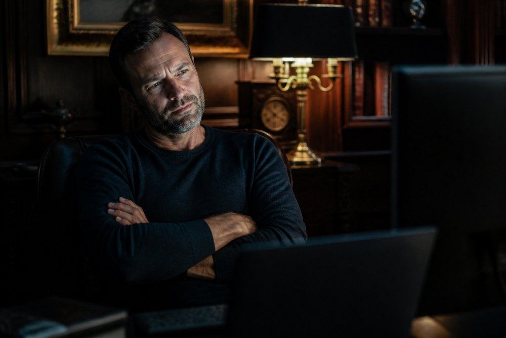 A skeptical buyer in a dim study.